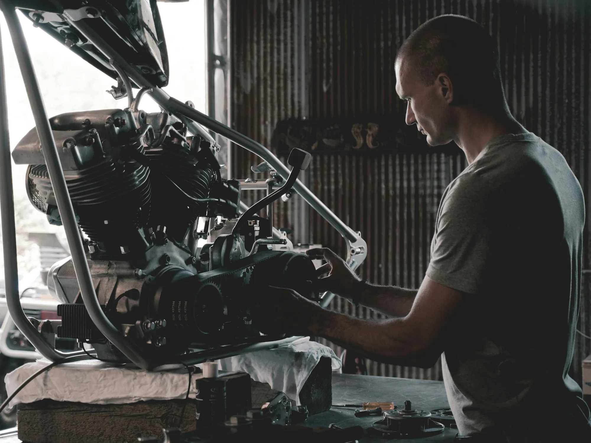 Mechanic working on an engine mounted on a stand in a workshop